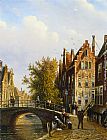 Figures Canvas Paintings - A Dutch town with figures on a canal